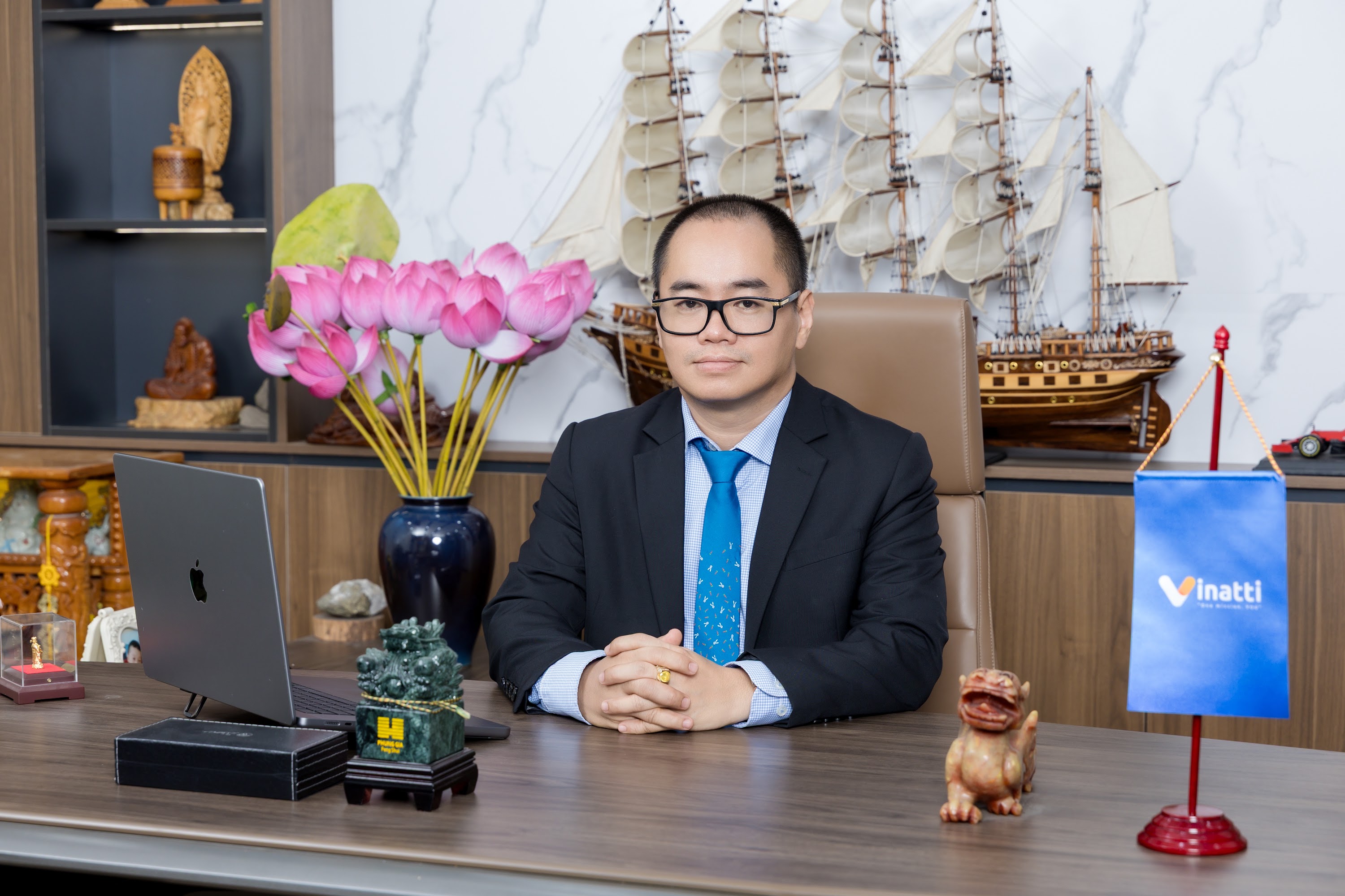 Vu Quoc Dung, Chief Executive Officer of Vinatti, seated at his office desk